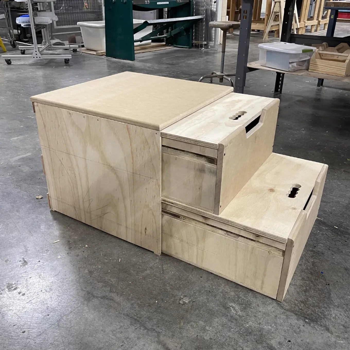 Finished plywood step stool with two pull-out drawer steps.